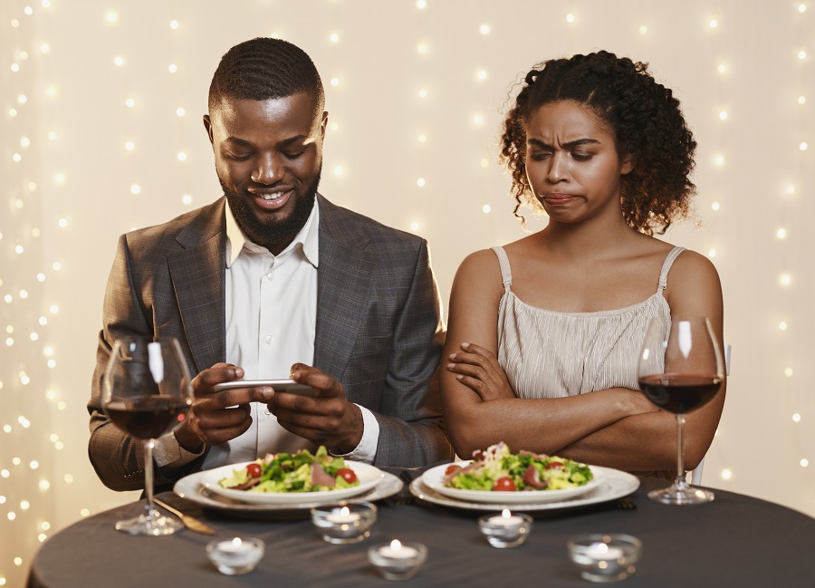 Man on phone while on a date